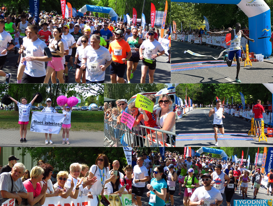 Zawodnicy biegną ulicami Krapkowic podczas Krapkowickiego Biegu Ulicznego z kibicami dopingującymi na trasie.