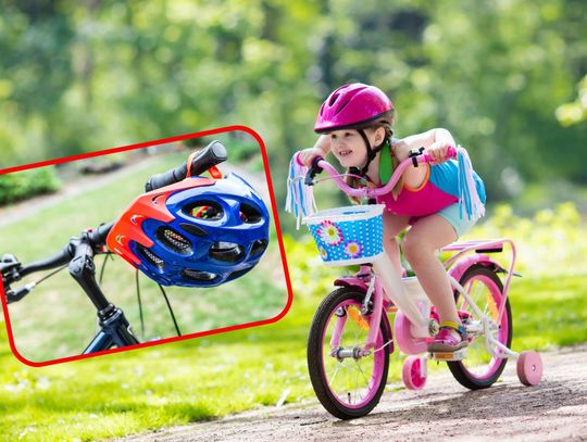 Dziecko w kasku jadące na rowerze po ścieżce rowerowej