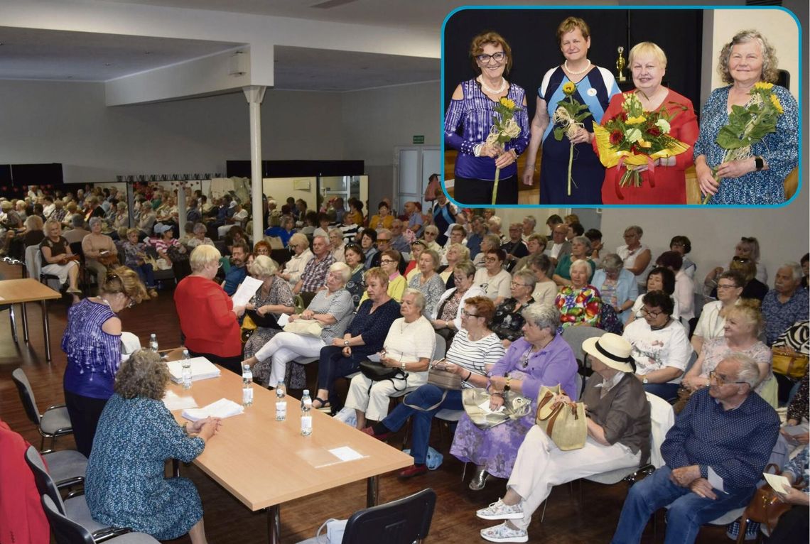 Seniorzy uczestniczący w zebraniu sprawozdawczo‑wyborczym UTW w Krapkowicach, w sali wypełnionej słuchaczami.
